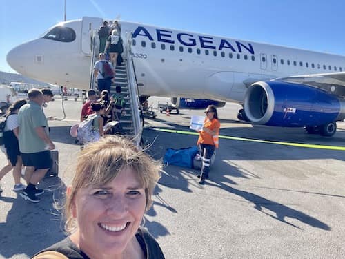 woman taking selfie with airplane in the background
