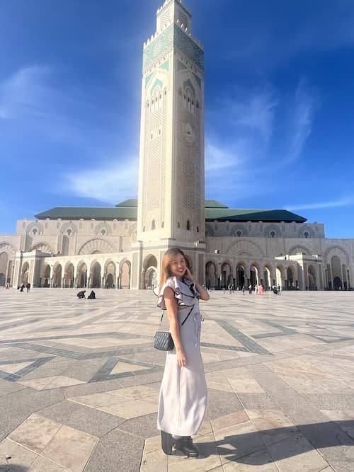 Haruka standing in front of the Hassan II Mosque in Morocco
