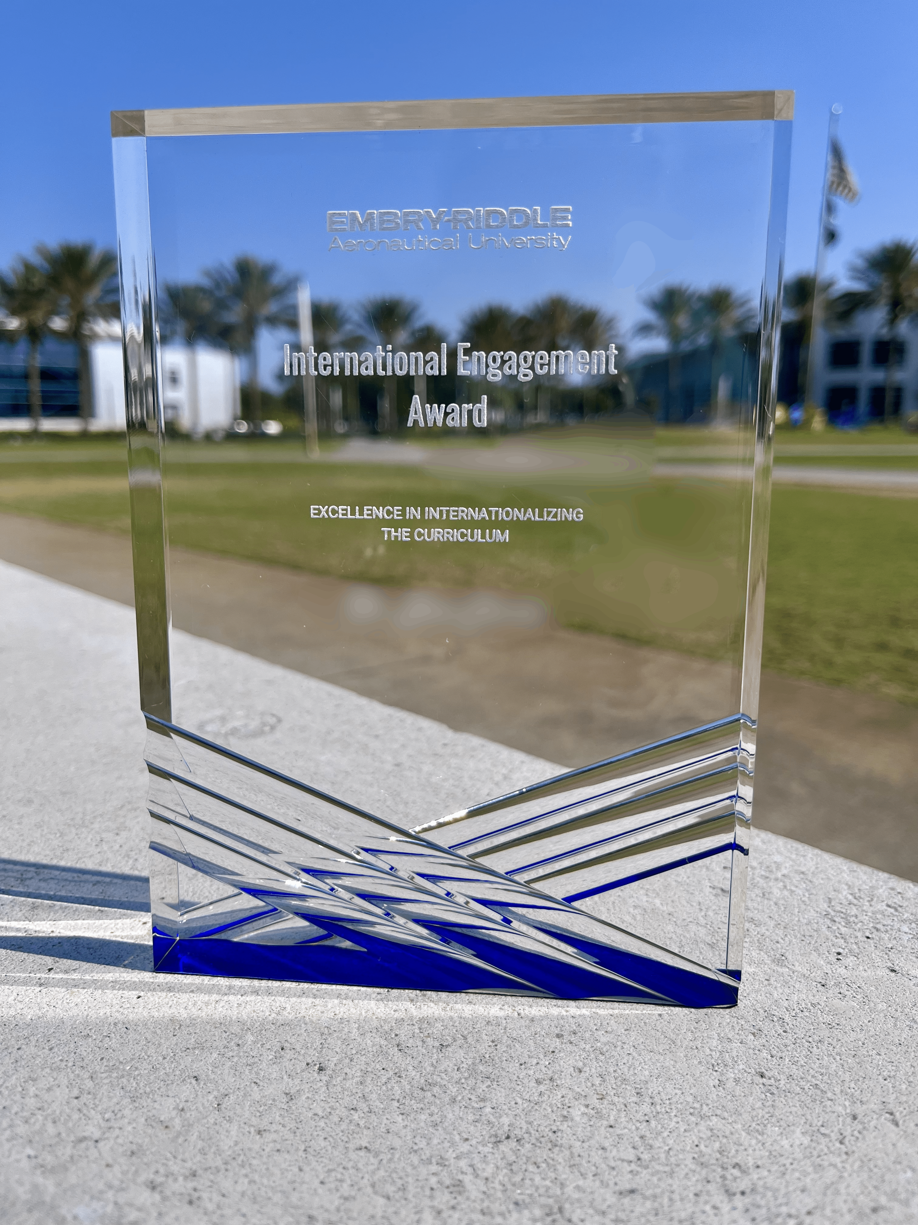 A glass rectangle award with the words International Engagement Award Excellence in Internationalizing the Curriculum.