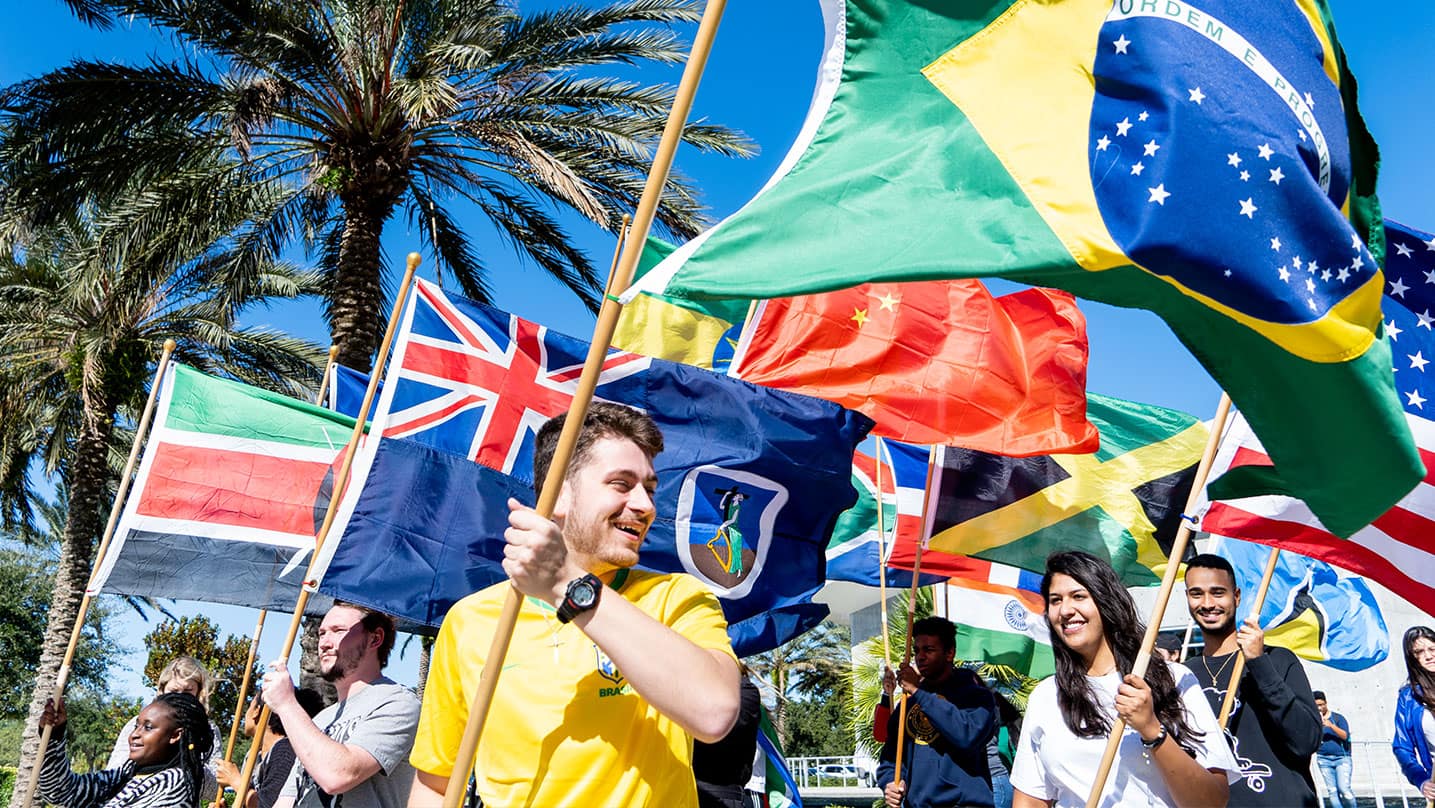 Embry-Riddle international students celebrating with flags from different countries