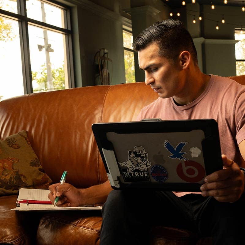 Student working on laptop computer in cafe