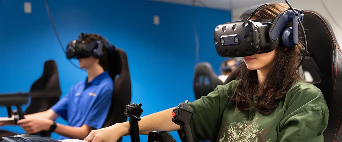mbry-Riddle student Laurayna Pick, a freshman Aeronautical Science major, conducts virtual-reality flight training maneuvers at the Advanced Flight Simulation Center.