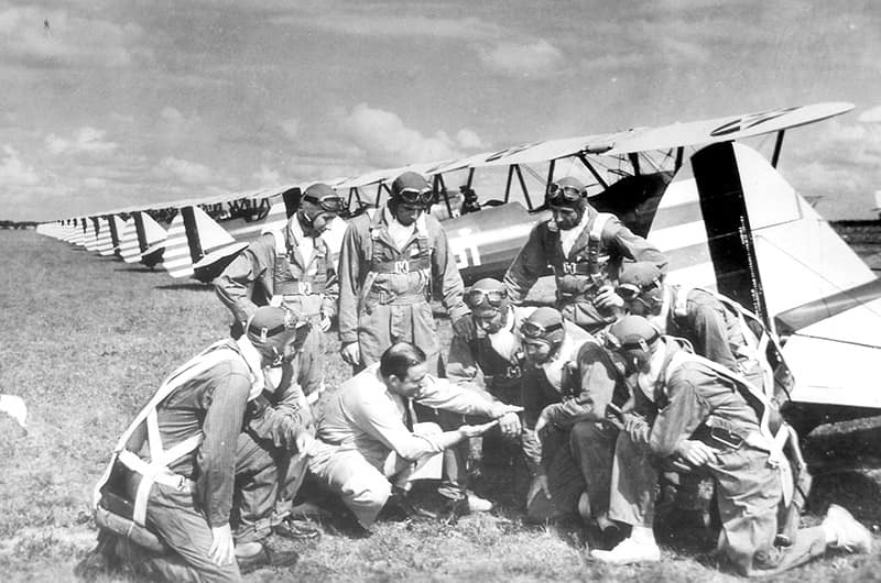 Men in uniform inspecting plane