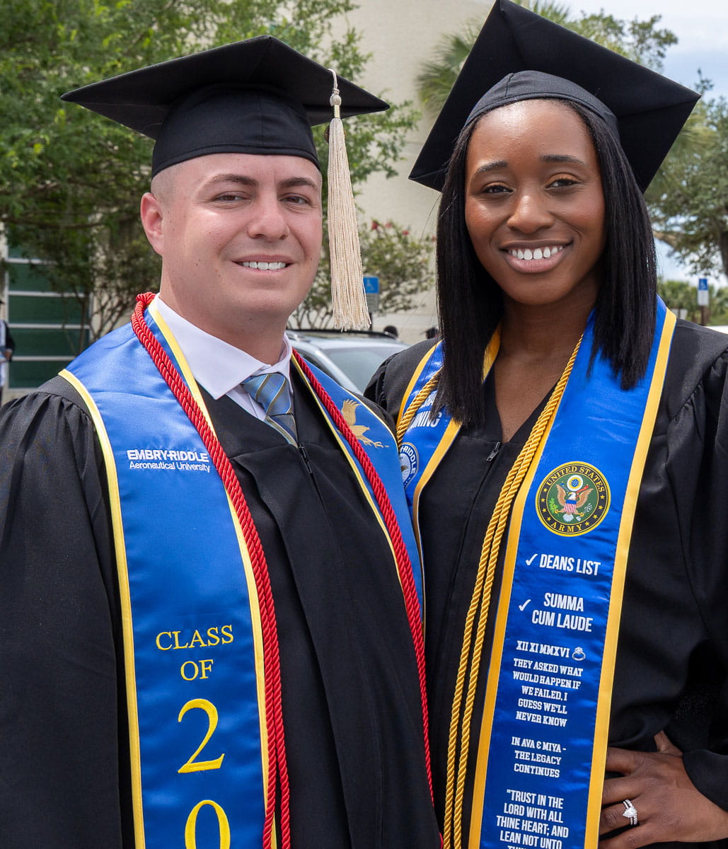 Married couple stands together after graduation
